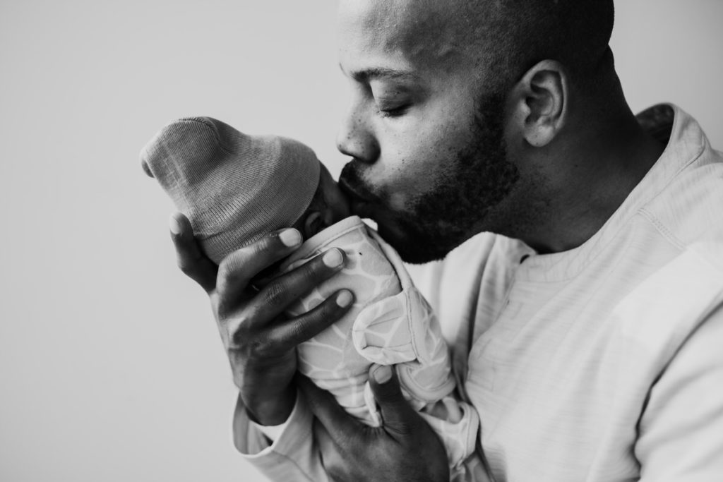 dad kissing his newborn son during their fresh 48 photo session at lake forest hospital