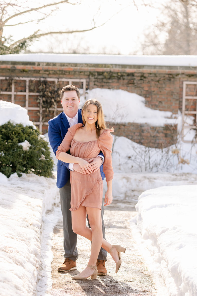 couple posing for Chicago Engagement photos in snow