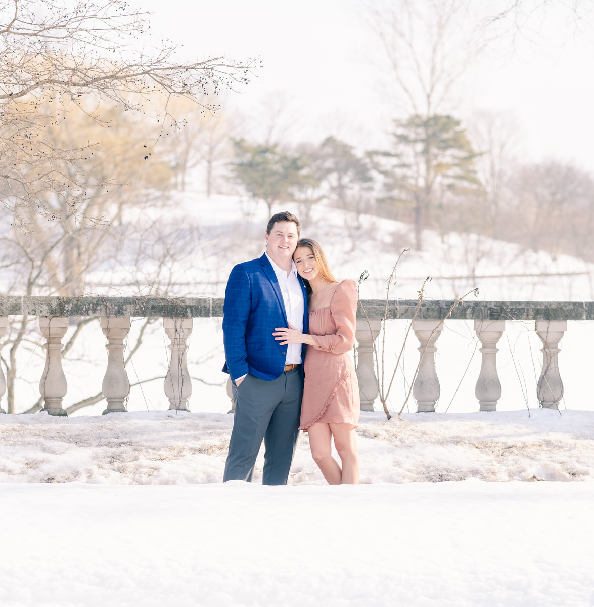 couple posing for engagement photos in snow