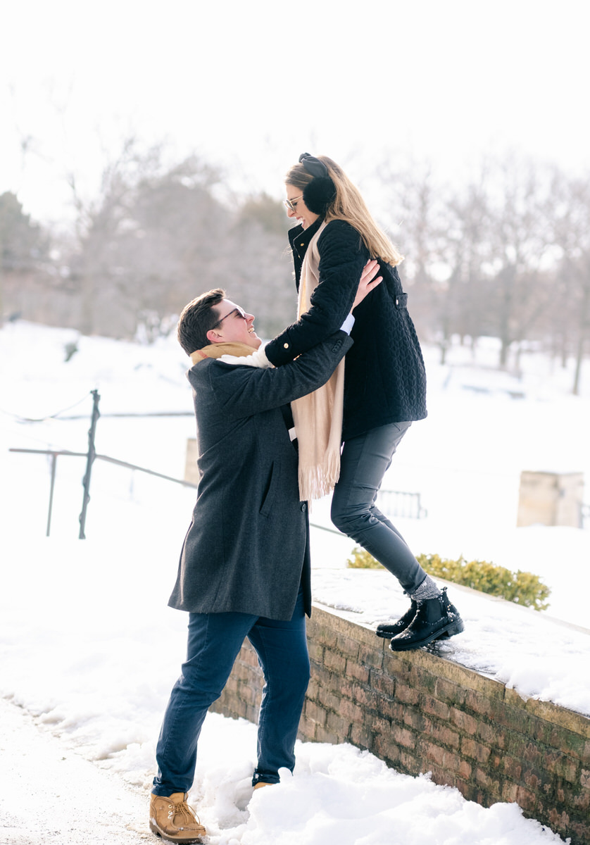 man catches girlfriend as she jumps from rock ledge during Chicago Engagement photos