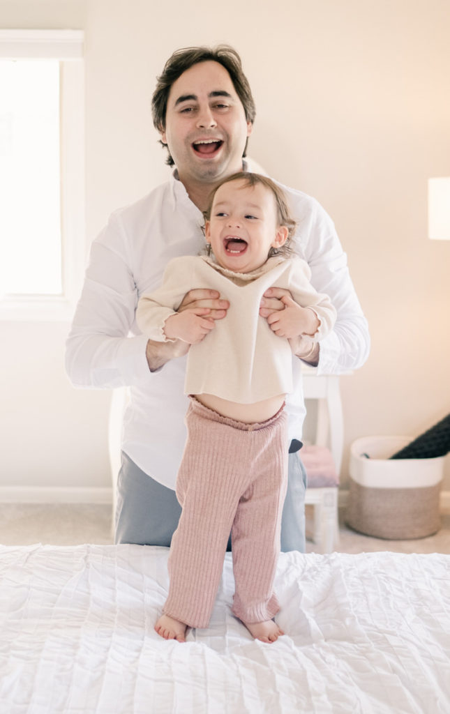 toddler laughing with dad