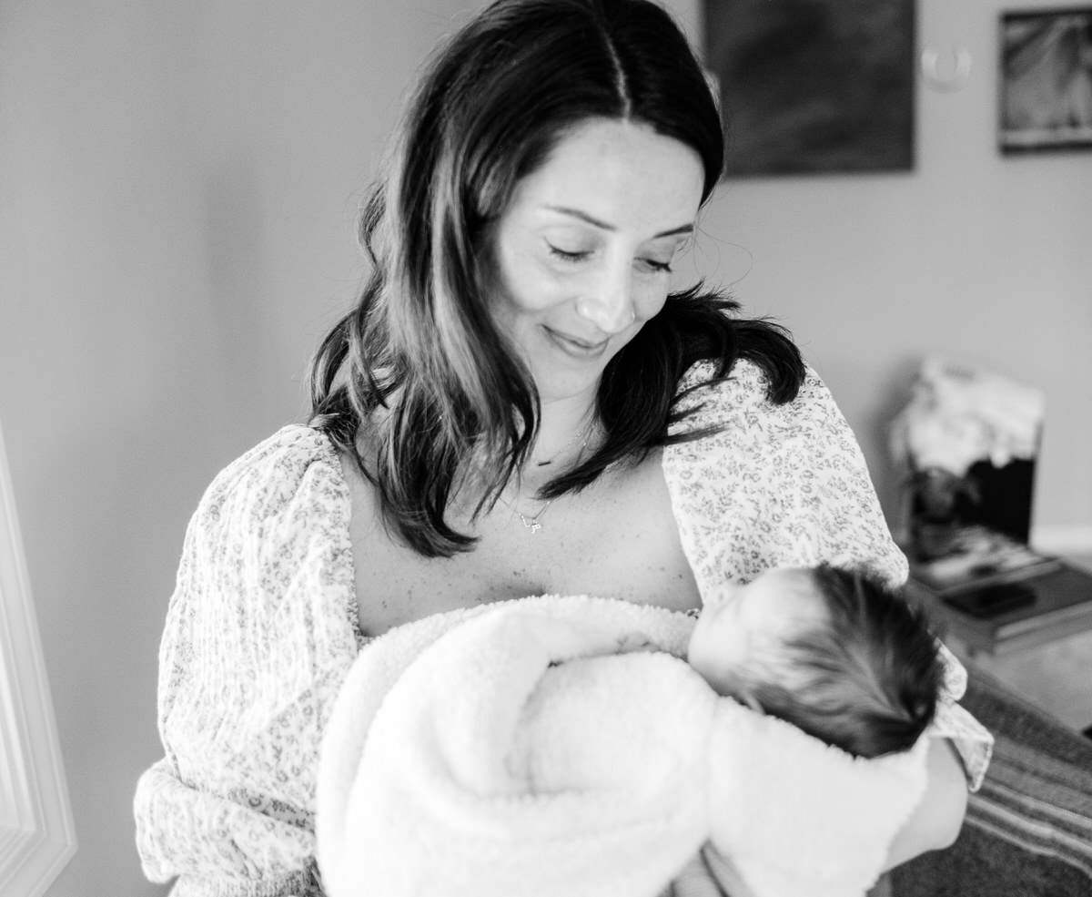 mom holding newborn during Evanston Newborn Photos