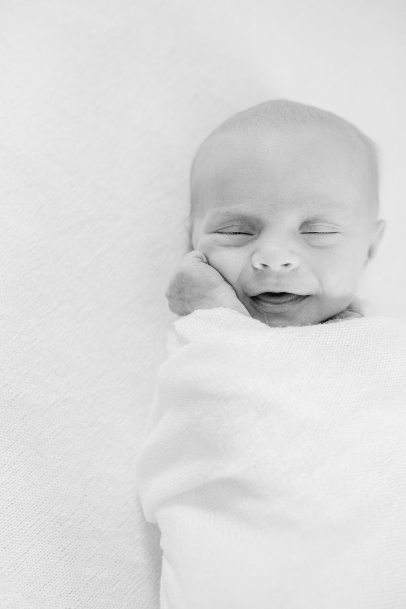 smiling newborn in black and white