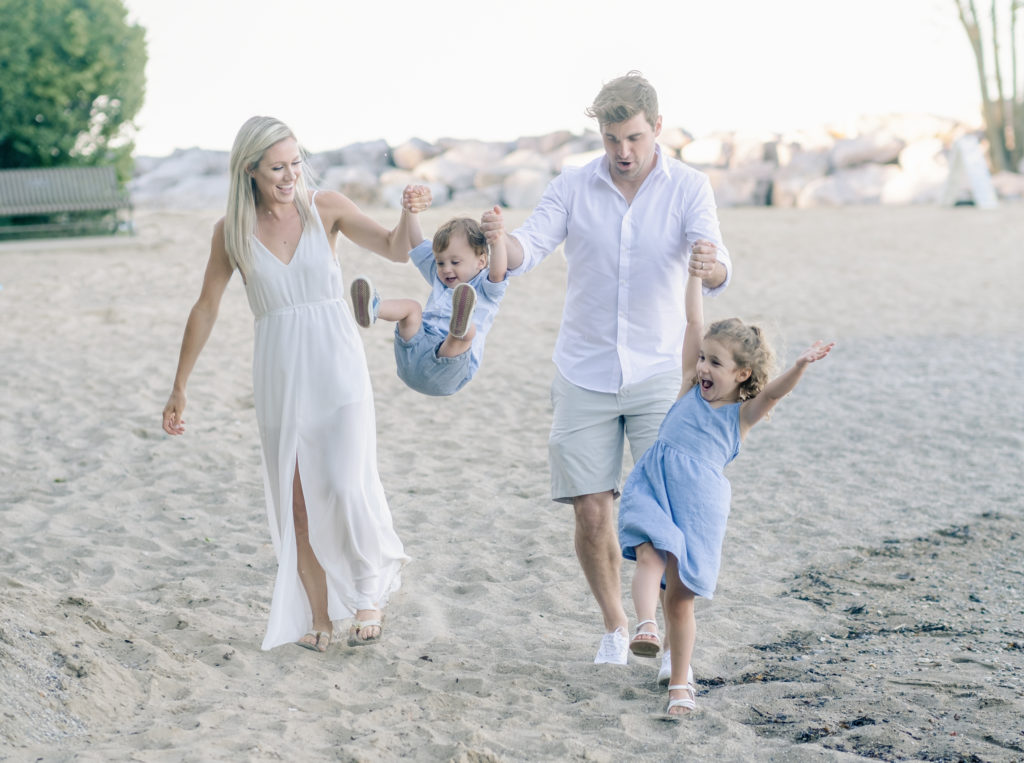 a family playing on the beach during their evanston family photography session