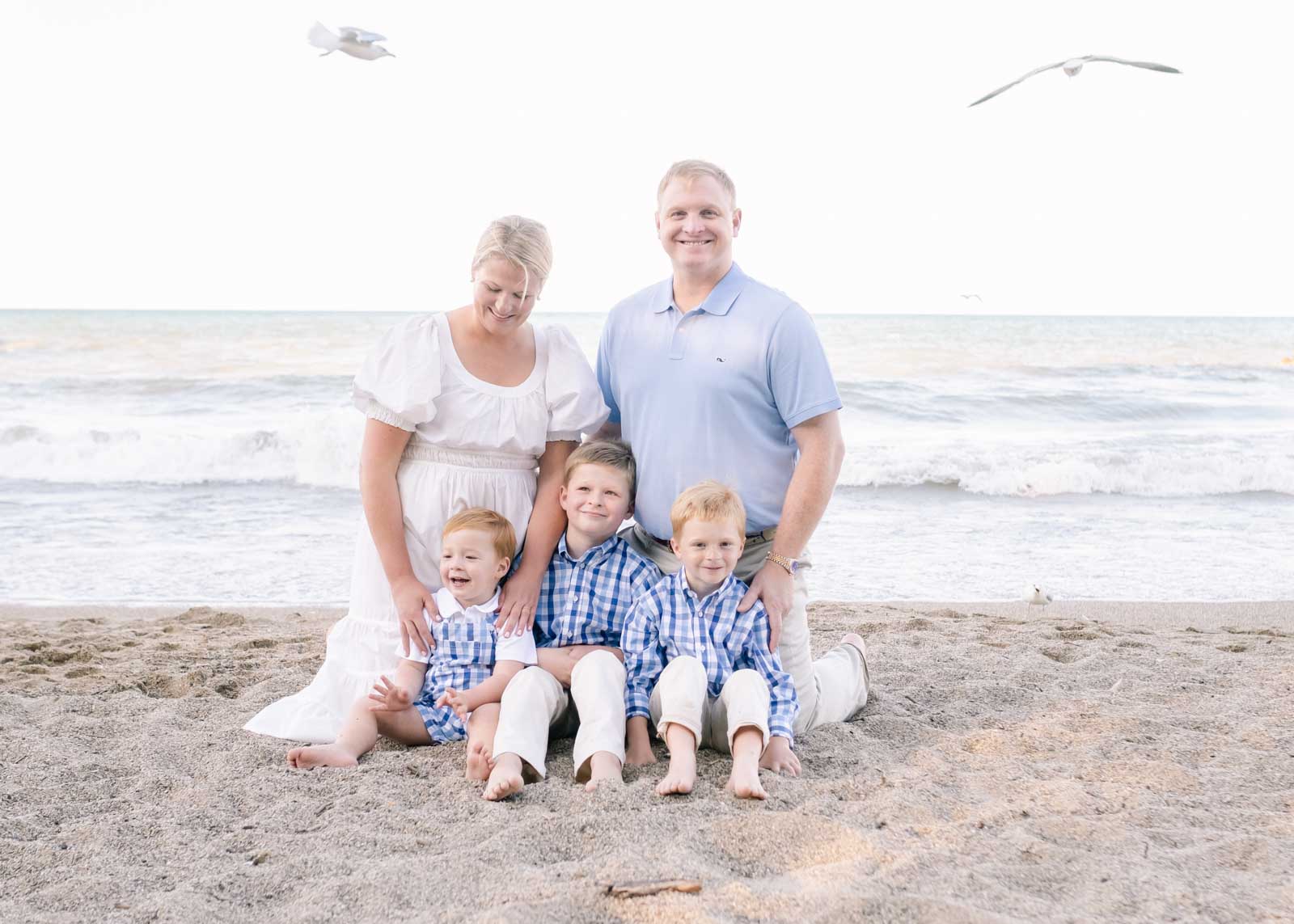 Wilmette photographer captures family posing for their annual portrait along Lake Michigan's beach.