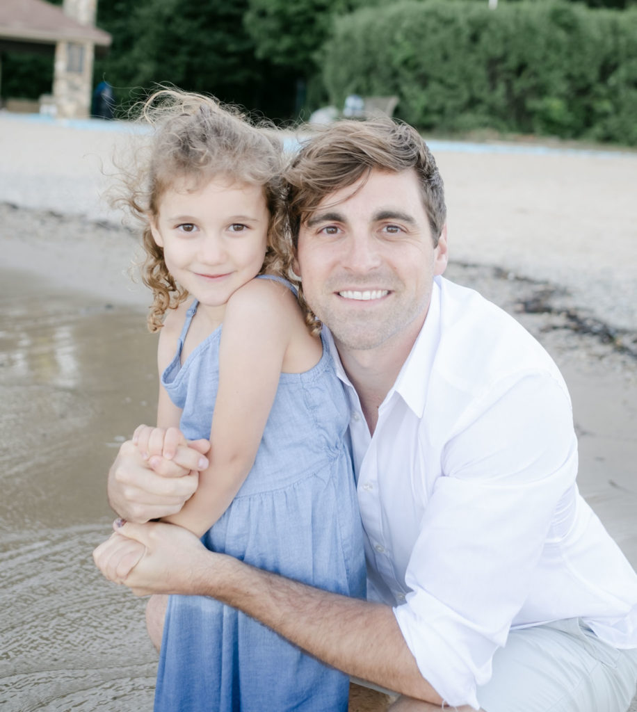 a portrait of a dad and his daughter on lake bluff beach