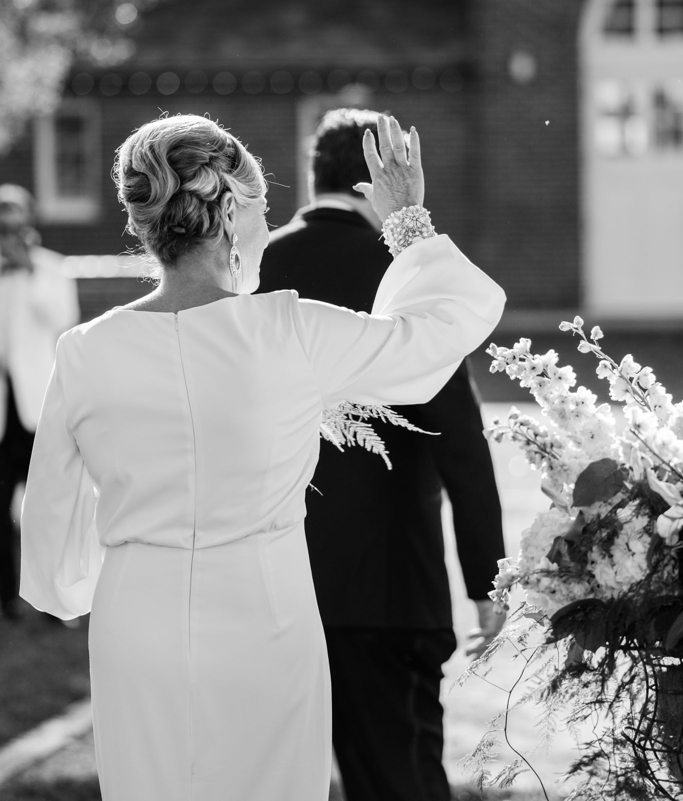 a bride greets her elawa farm wedding guests with a wave