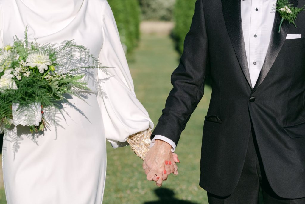 close up of a bride and groom holding hands after their vows at Elawa Farm
